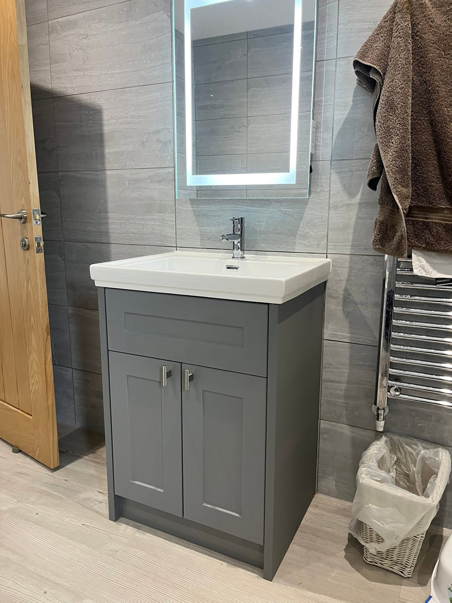 New grey vanity unit and basin with illuminated mirror